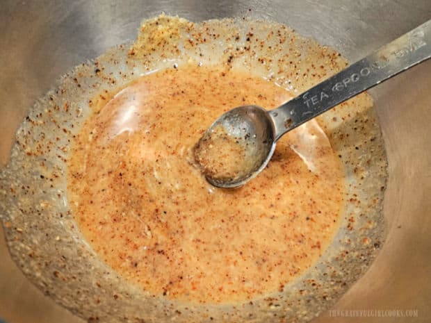 Ingredients used to season the salmon fillet are combined in a small bowl.