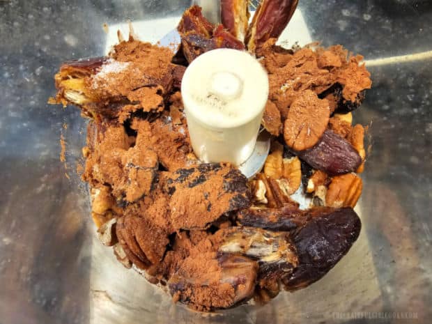 A food processor is used to finely chop and combine energy ball ingredients.