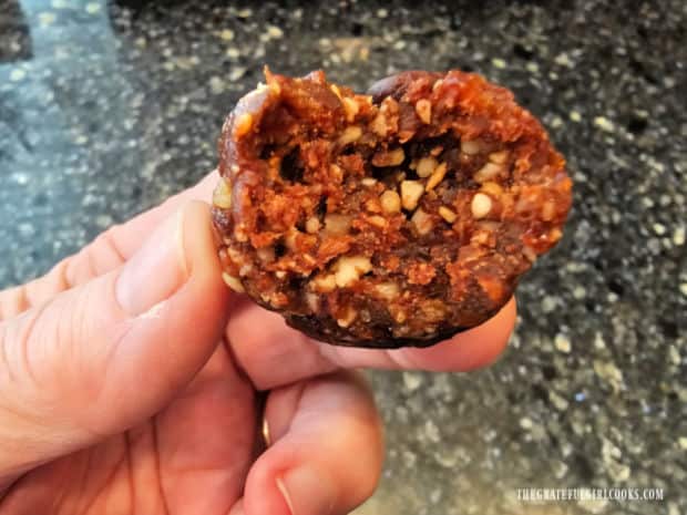 A closeup picture of the inside of one of the chocolate energy bites.