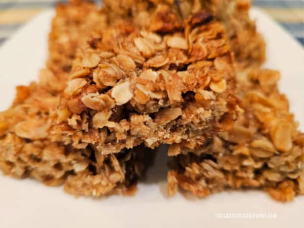 A stack of crunchy oatmeal marmalade bars on a white plate.