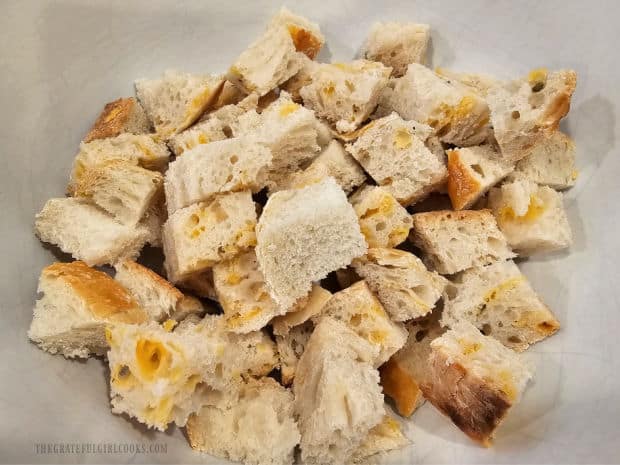 Sourdough or French bread is cut into cubes and placed in a bowl.