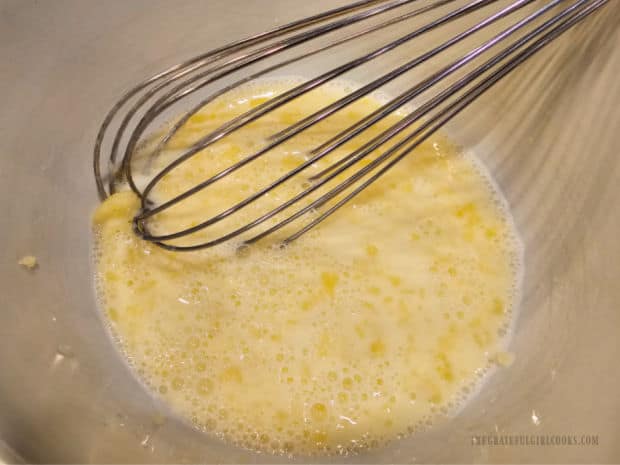 A whisk is used to fully combine the egg, milk and butter.