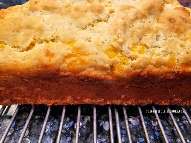 A side view of the loaf of cheddar cheese bread after it is removed from the pan.