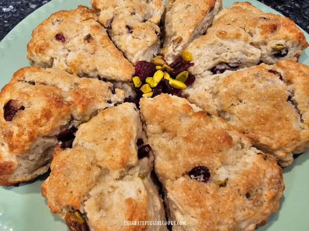 A serving plate full of cranberry pistachio scones, ready to be served and enjoyed.
