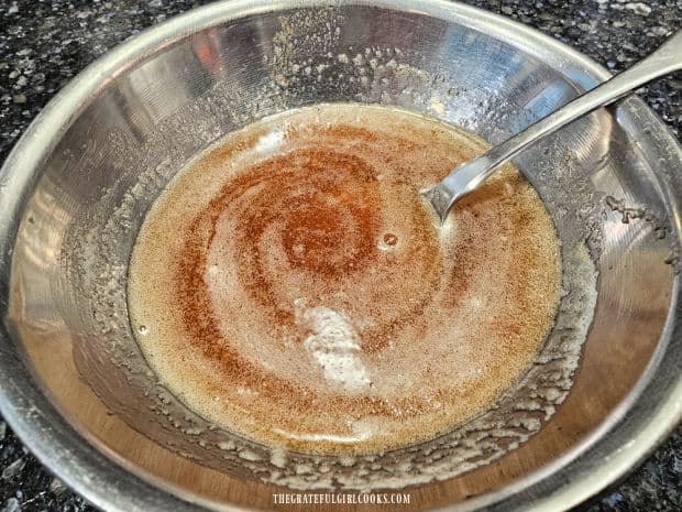 Maple syrup is stirred into a bowl holding the browned butter.