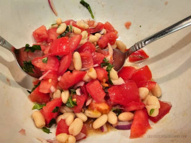 Mixture is tossed to combine with salad dressing, then marinates for 20 minutes.