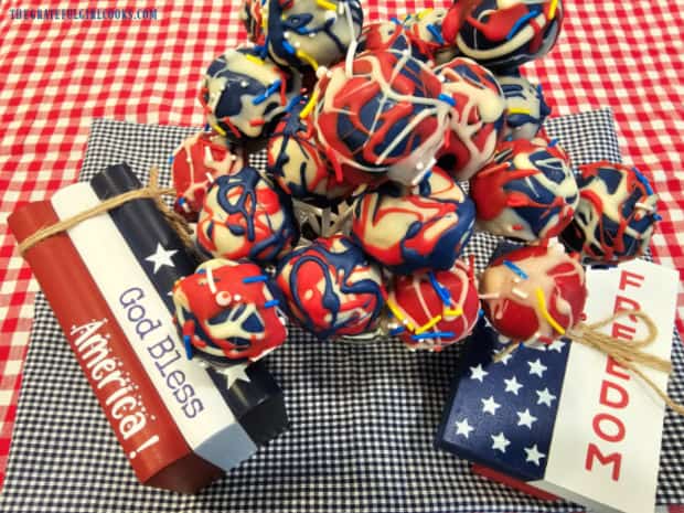 Two July 4th decorations along with a lot of patriotic chocolate balls in the center.