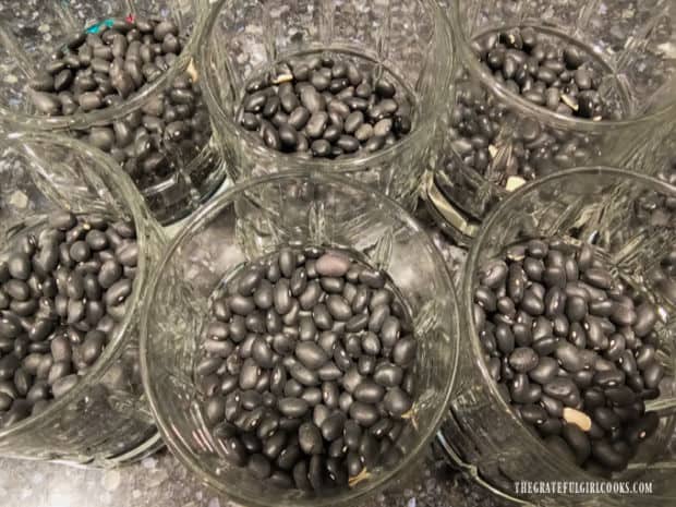 Dried beans in juice glasses create a secure base to hold the chocolate pops upright.