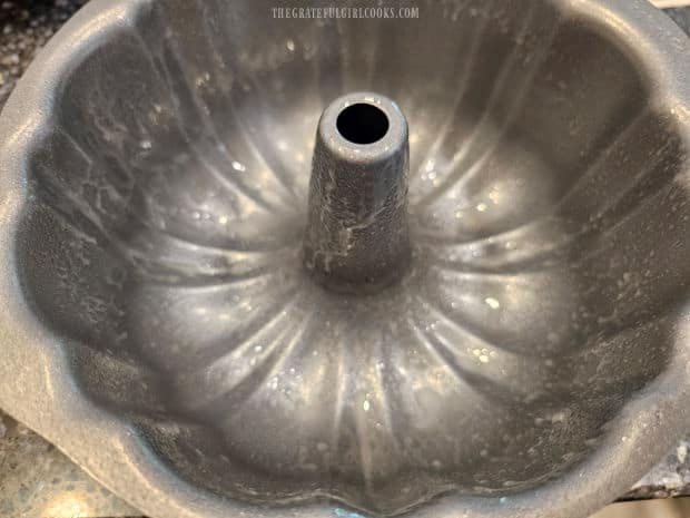 Air Fryer Banana Pecan Cake - The Grateful Girl Cooks! A small bundt pan is greased well before filling with batter.