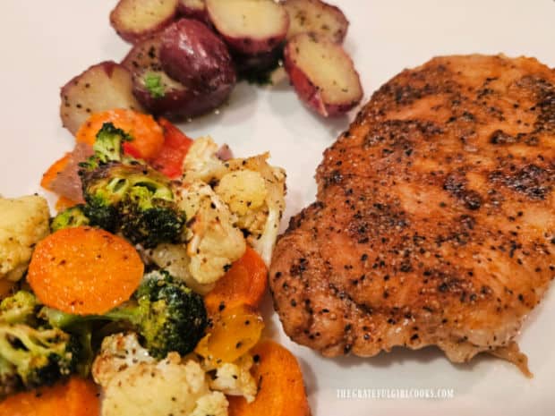 Air fryer veggies for two served with red potatoes and a pork chop.