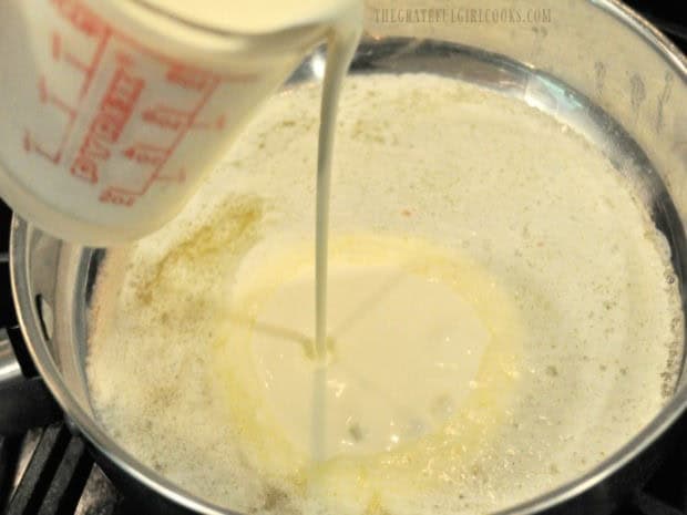 Heavy whipping cream is added to melted butter in a saucepan.