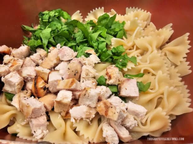 Chicken and chopped spinach are added to drained, hot bowtie pasta.