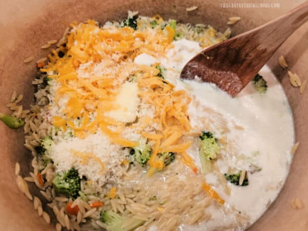 Cheddar and Parmesan cheeses, whipping cream and butter are stirred into orzo.