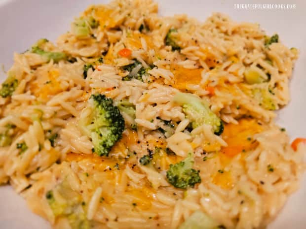 The broccoli cheese orzo, served in a white bowl.