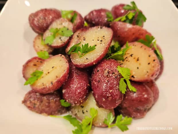 Fresh parsley is sprinkled on the hot garlic butter red potatoes.
