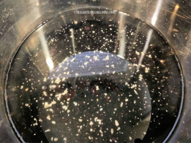 black beans, garlic and salt are fully covered with 6 cups of water in the Instant Pot.