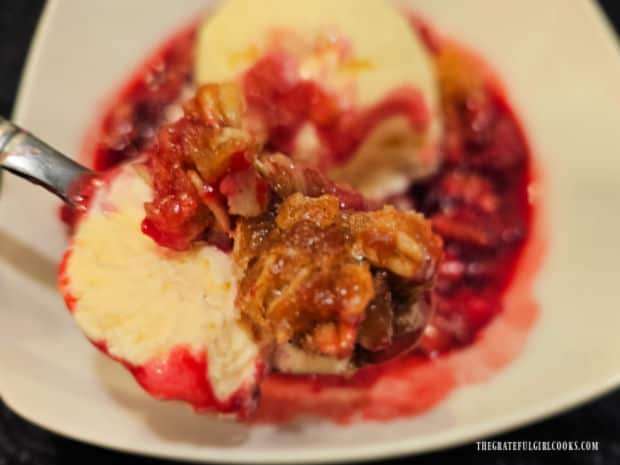 A spoonful of blackberry crisp with ice cream is ready to enjoy!