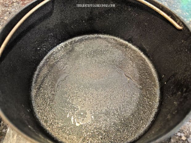 A 7" round baking pan is greased well before filling with blackberry mixture.