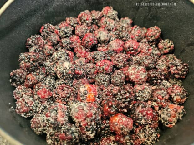 The sugar-covered blackberries are placed in a 7" greased baking pan.