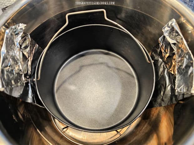 A "sling" made from aluminum foil is shown to help lift the pan out of the pot.