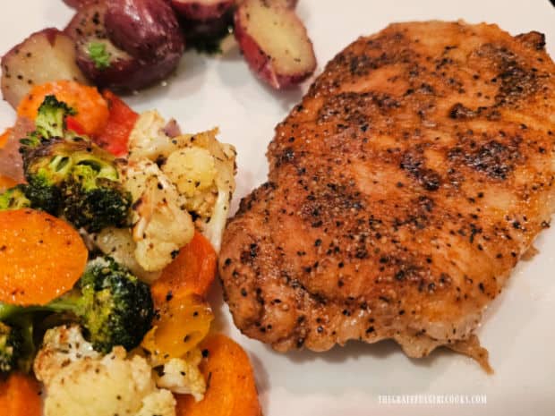 Red potatoes and veggies are served along with the Instant Pot Boneless Pork Chops.