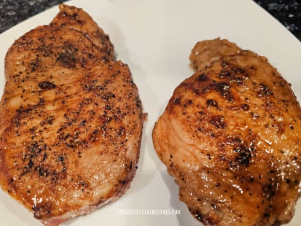 Pork chops are removed from the pot to rest on a plate after they're lightly browned.