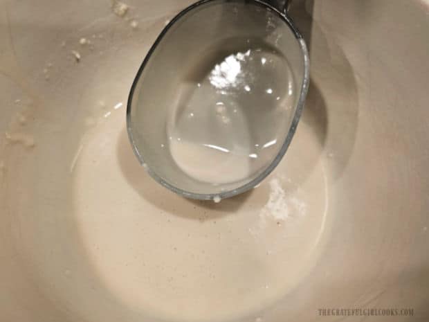 Scooping out the batter to make homemade waffles.