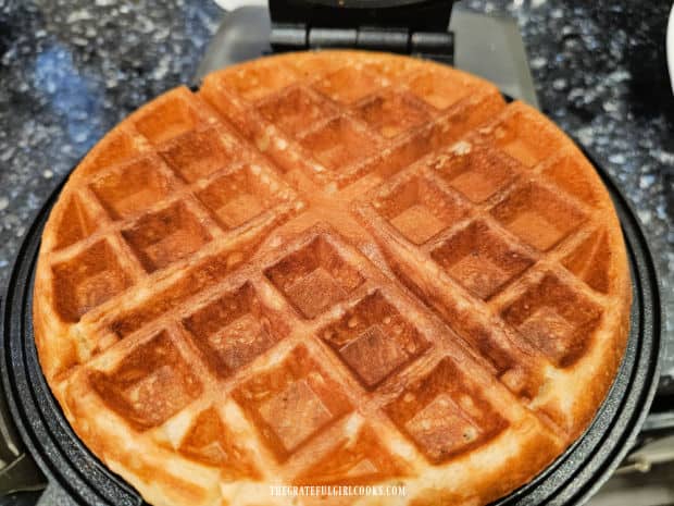 A crispy brown waffle is ready to add Nutella and fruit to, and then enjoy!