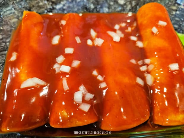 Air Fryer Cheese Enchiladas - The Grateful Girl Cooks! Enchilada sauce and chopped onions top the enchiladas in dish.