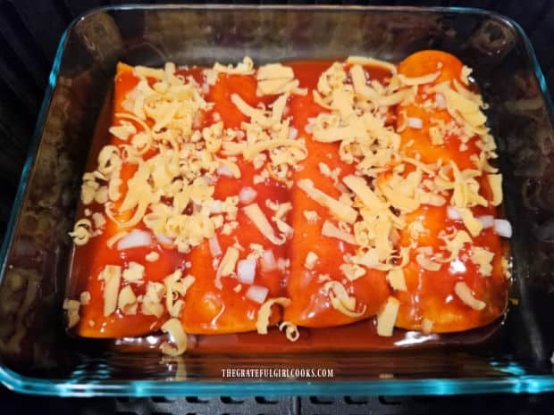 Air Fryer Cheese Enchiladas - The Grateful Girl Cooks! Grated cheddar cheese is divided on top of the cheese-filled enchiladas