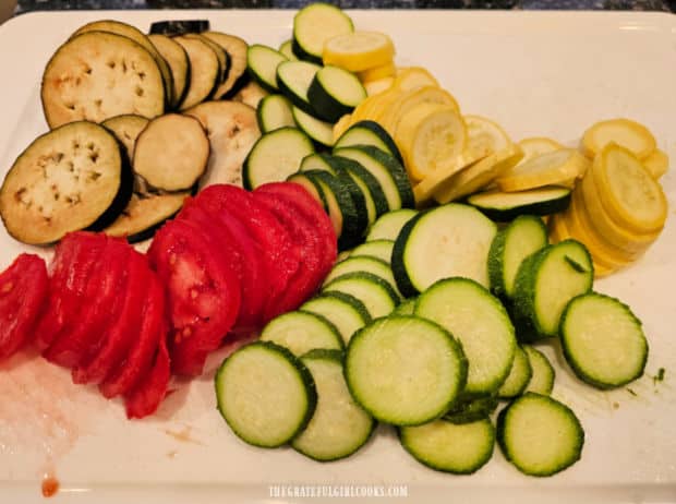 The veggies are sliced into ¼" thick rounds before layering them in a pan.