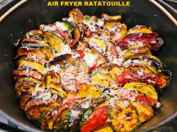 Make a flavorful Air Fryer Ratatouille with eggplant, zucchini, yellow squash, tomatoes, onions, garlic and spices, and topped with Parmesan.