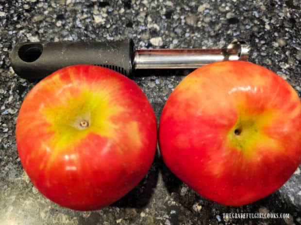 Two Honeycrisp apples and an apple corer.