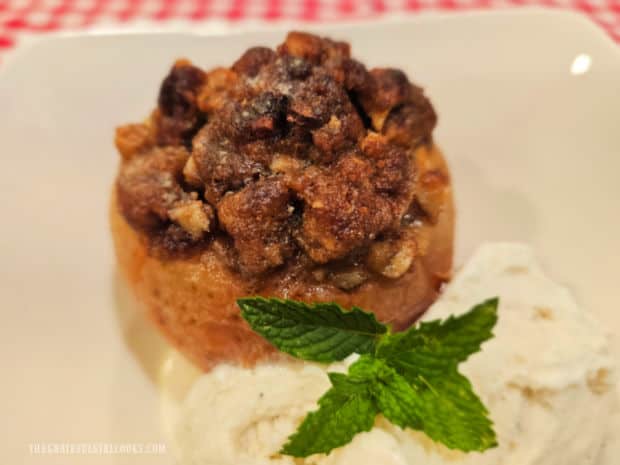 Baked Apples For Two are served with vanilla ice cream topped with a mint leaf.