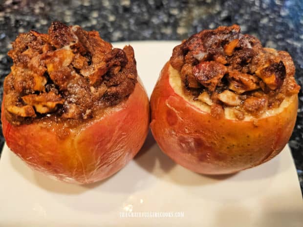 Two baked apples rest and cool slightly before serving.