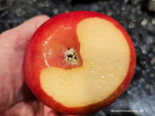 A small slice is cut off the apple bottom to ensure it can stay level in baking dish.