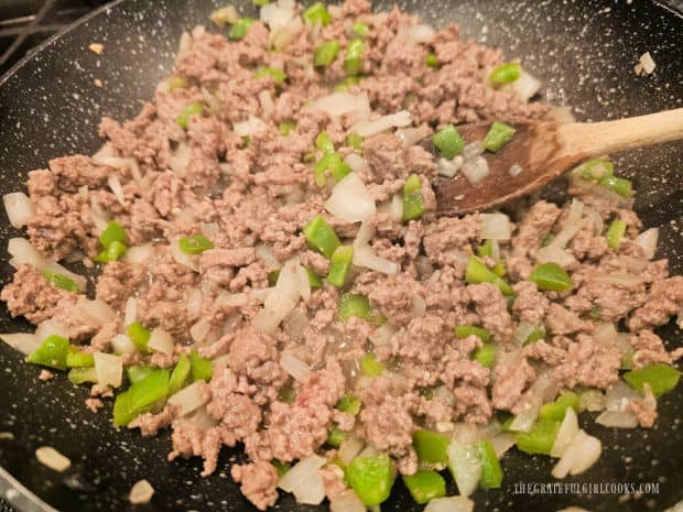 Ground beef is fully cooked, browned and in very small pieces when done.