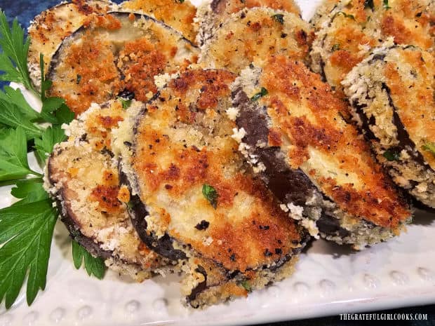 Crispy Eggplant Milanese is transferred to a platter and garnished with parsley.