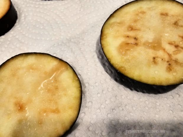 Salt on the eggplant draws out extra moisture in each piece before they are patted dry.