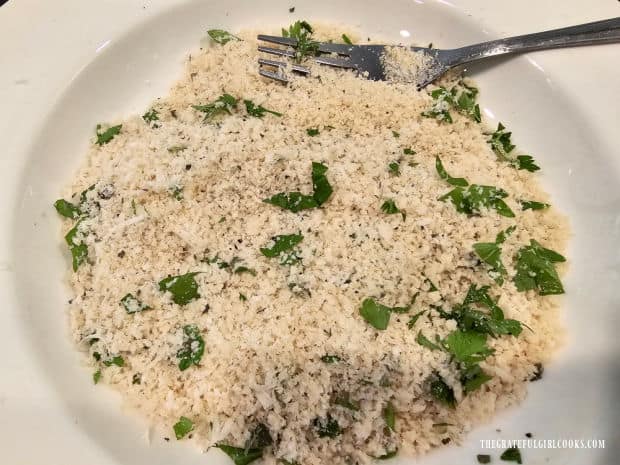 Panko breadcrumbs and herbs are combined in a bowl for the last topping.