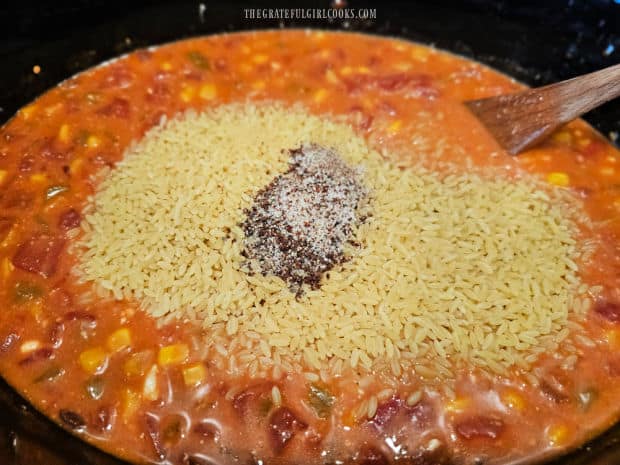 Crockpot Cheesy Enchilada Orzo - The Grateful Girl Cooks! Dried orzo, spice mix and more vegetable broth added to the crockpot to continue cooking.