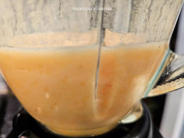 This is a side view of the fully blended peached and pink lemonade in the blender.