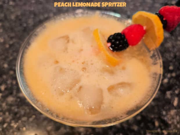 Hot outside? Make Peach Lemonade Spritzer (for two), a family-friendly cold drink with pink lemonade, fresh peaches and lime sparkling water!