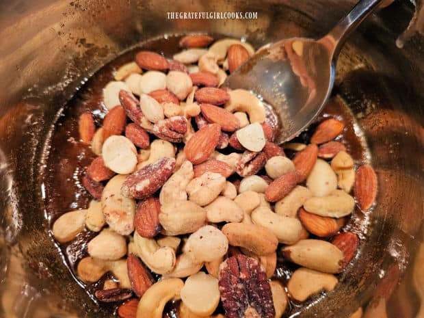 Roasted, salted mixed nuts are gently stirred into the candied topping mixture.