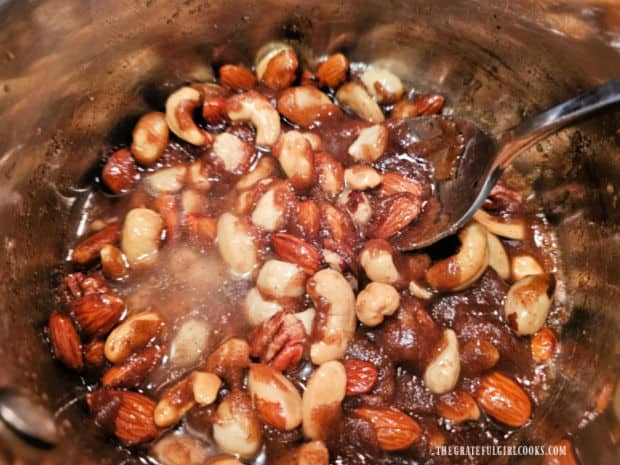 Mixed nuts are stirred into the candied topping mixture and brought to a boil.
