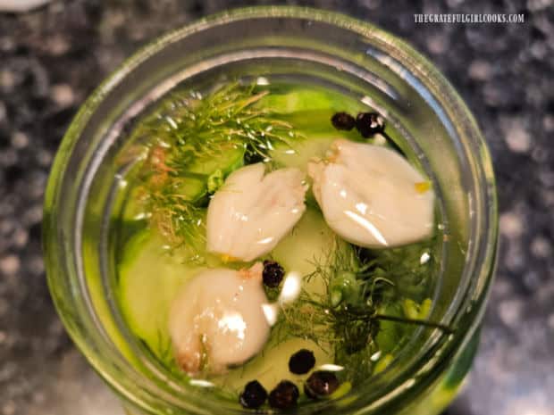 Refrigerator Dill Pickle Slices - The Grateful Girl Cooks! Smashed garlic cloves, dill and peppercorns add lots of flavor to the pickle brine.