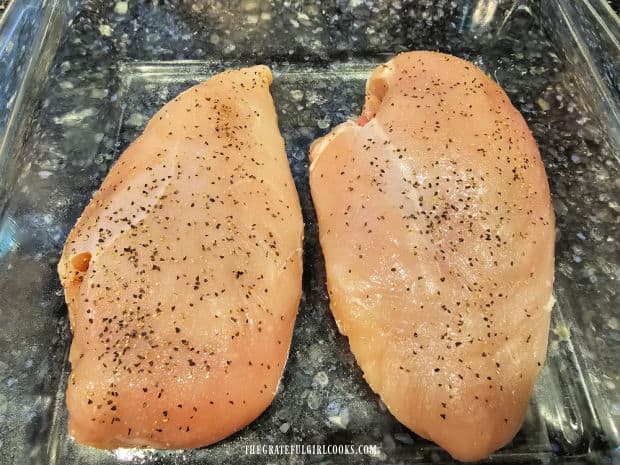 Artichoke Chicken Bake For Two - The Grateful Girl Cooks! Two chicken breasts patted dry and seasoned with salt and pepper, in baking dish.