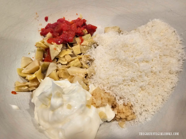 Artichoke Chicken Bake For Two - The Grateful Girl Cooks! Mayonnaise, roasted red peppers, artichoke hearts, minced garlic and Parmesan in a bowl.