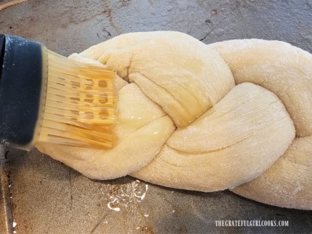 Oil is lightly brushed on challah bread before a second resting/rising.