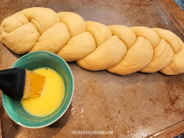 Before baking, challah bread is brushed with an egg wash.